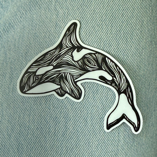 Black and white stylized orca whale design on a textured gray background